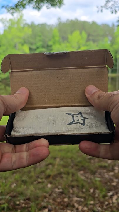 Opening a Barrel&Blade knife box beside a lake