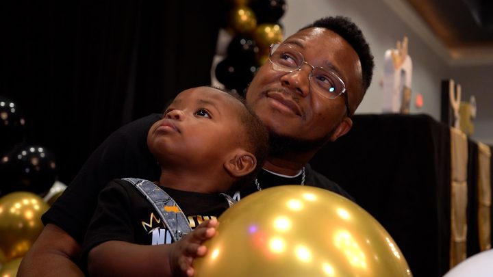 Dad looking down at the birthday boy