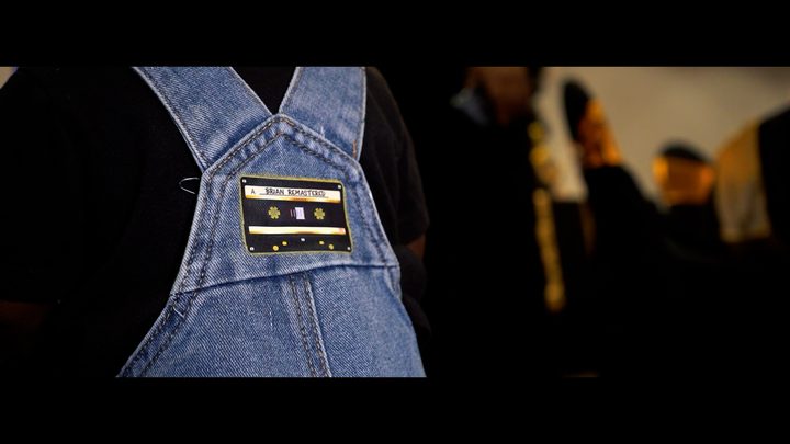 Denim overalls with a cassette tape patch