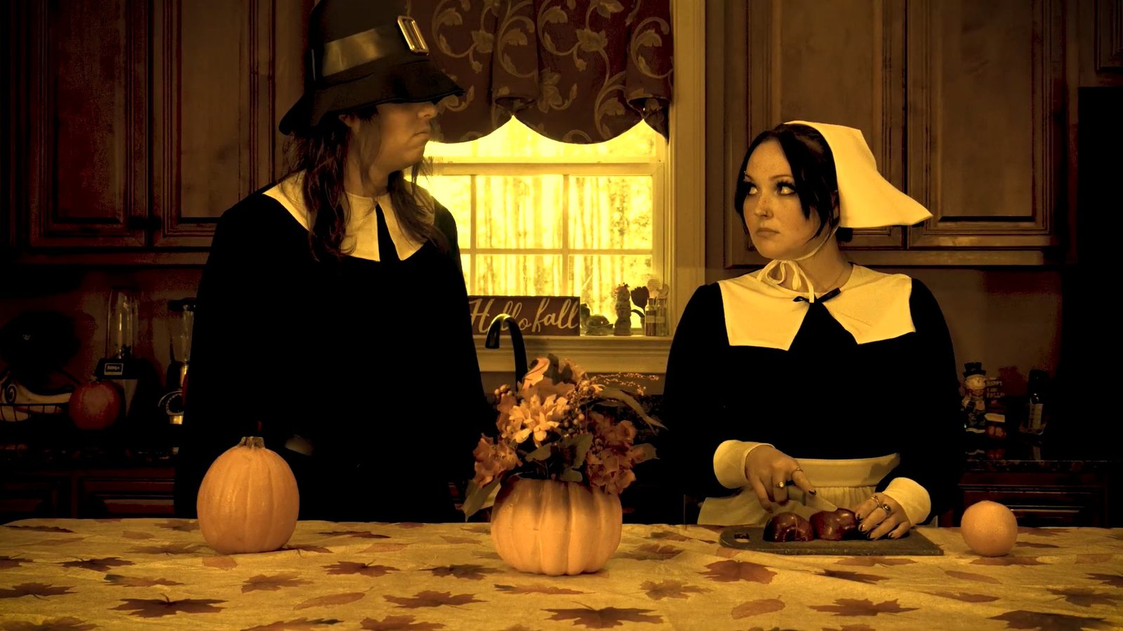 Two pilgrims in a warm-lit kitchen, from one of the fake trailers
