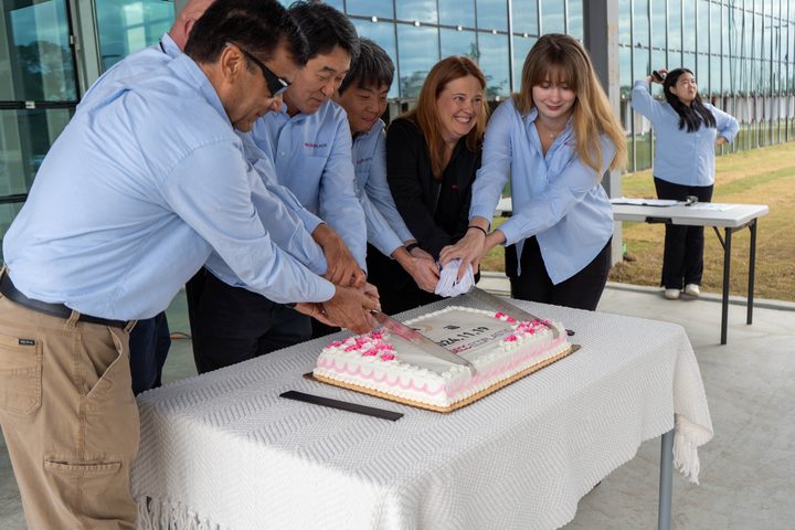 Leadership cutting the completion cake together