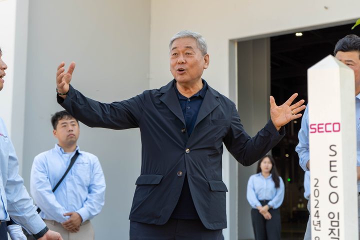 The CEO speaking beside the SECO commemorative marker