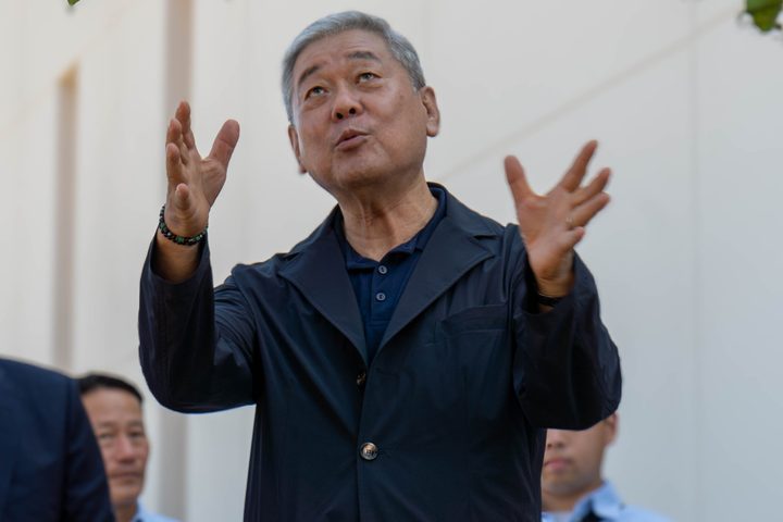 The CEO mid-story, hands raised