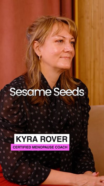 Kyra Rover, certified menopause coach, on a red couch with her name lower third